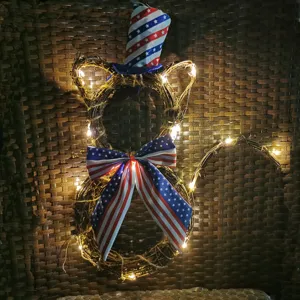 Close-up of cat-shaped twig wreath with LED lights, patriotic US flag hat and bow for holiday.