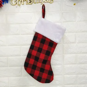Red and black buffalo plaid Christmas stocking with white plush cuff for holiday decor detail.