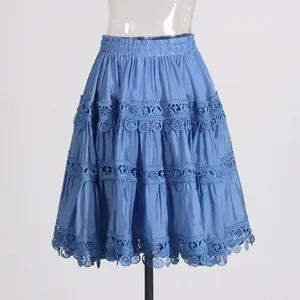 Detailed view of the elegant blue tiered midi skirt featuring intricate lace hollow design.