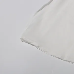 Close-up detail of smooth white fabric hemline and neat stitching texture for summer apparel.