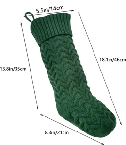 Green knitted Christmas stocking detail view with wave pattern design and dimension guide.