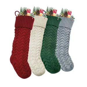 Knitted Christmas stockings set with festive filler decor, classic winter holiday hanging bags.