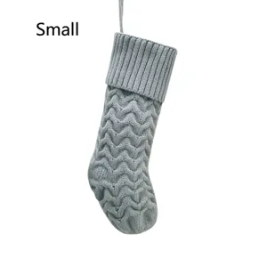 Small knitted Christmas stocking detail, grey chevron pattern holiday hanging decor.