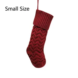 Red knitted Christmas stocking detail, small size holiday hanging decor gift bag for home party.