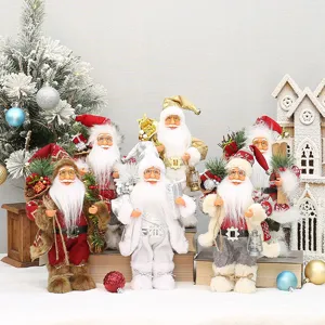 Detailed view of standing Santa Claus dolls with festive outfits and holiday decorations.