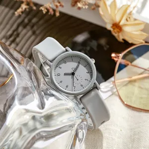 Minimalist quartz watch with grey silicone strap, classic round dial detail shot.