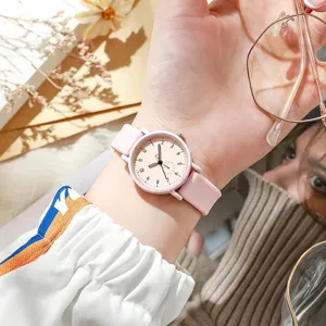 Pink silicone strap quartz women watch detail showing clear dial and soft candy color.