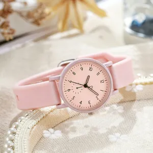 Close-up detail shot of the pink silicone strap quartz watch dial, showing clear numbers.
