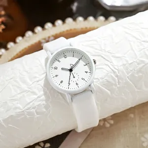 Minimalist white quartz watch detail, soft silicone strap and clear dial markers for daily wear.