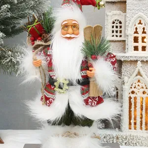 Standing Santa Claus figurine holding skis and gift bag for Christmas home decor detail view.