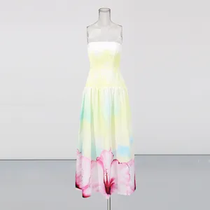 Close-up detail of the gradient yellow strapless long dress featuring a striking pink floral hem.