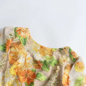 Exquisite floral embroidery women dress detail, mesh design with vibrant 3D flowers for summer.