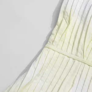 Detailed view of the stylish gradient light yellow pleated waist-cinching maxi dress.