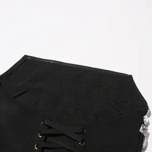 Black bandage dress detail with lace up corset design and rhinestones sparkling on the side