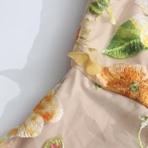 Close-up of women's floral embroidered mesh dress, showing exquisite 3D floral details.