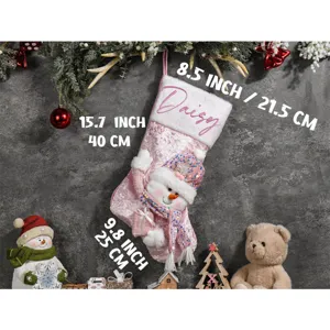 Rosa Weihnachtssocke mit Plüschbund, Name Daisy und Schneemann-Design. Schöne Festtagsdeko.