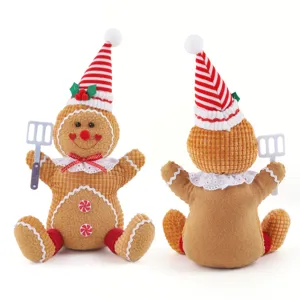 Christmas gingerbread man plush toy doll holiday decoration with cute striped hat and spatula.