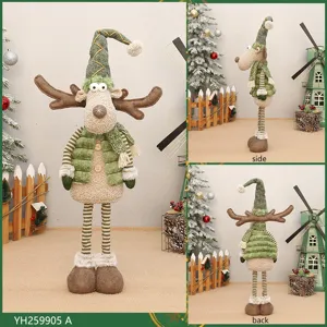 Details showing the retractable long leg Christmas deer plush doll, green festive desktop decor.