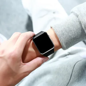 Detailed close-up view of the square electronic digital watch with a black silicone strap.