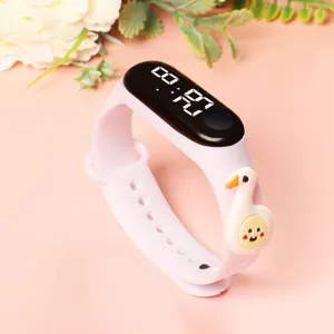 Detail view of cute pink kids LED digital watch with lovely duck charm on silicone band.