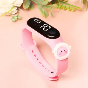 Kids cute pink silicone electronic watch with LED digital screen and cartoon sheep decor.