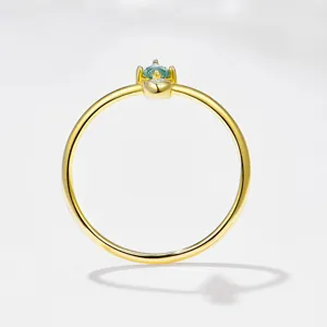 Detail shot of the dainty s925 silver green moss agate ring, featuring a slim gold band.