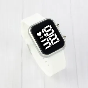 Detailed close-up of white LED digital watch featuring square silver case and silicone strap.