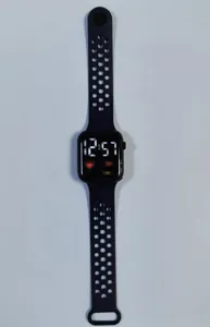 Detailed shot of a black square LED digital sports watch with breathable silicone strap.