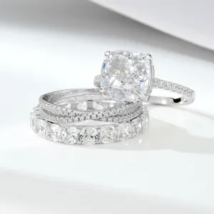 Cushion cut cubic zirconia bridal ring set detail, sparkling silver wedding bands.
