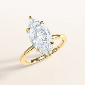 Marquise cut zirconia solitaire ring detail shot, showing brilliant crystal facets and polished gold band.