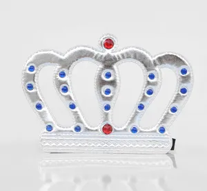 Close-up detail of the silver fabric crown prop decorated with colorful gems for parties.