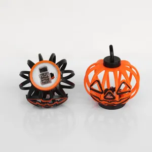 Halloween hollow pumpkin candle lamp detail view, black and orange decorative lantern prop.