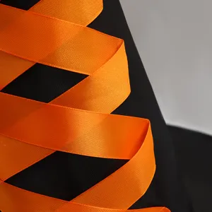 Halloween witch hat detail shot, black oxford cloth with bright orange satin ribbon decoration.