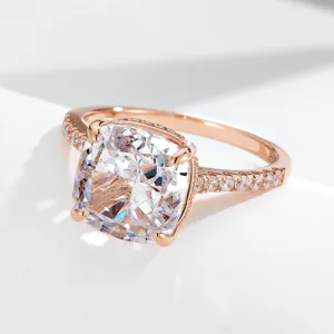 Close-up detail shot of a sparkling cushion-cut zircon ring in elegant rose gold finish.