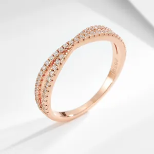 Exquisite rose gold twisted pave ring detailed close-up, sparkling cubic zirconia details