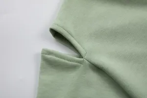 Light green cotton hoodie detail close-up, featuring neat stitching and casual style.