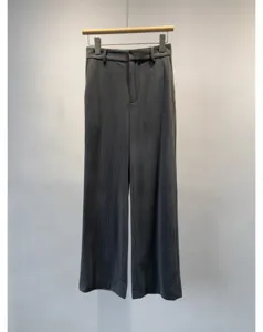 Grey corduroy wide leg trousers detail shot showing texture and tailoring, clean look.