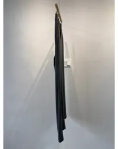 Detail view of the soft casual trousers hanging, showing fabric texture and straight cut line.