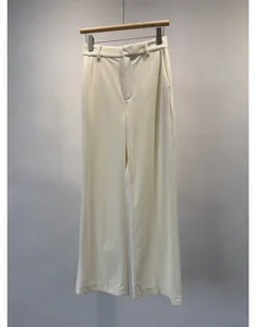 Detail view of casual corduroy wide-leg trousers, soft ribbed texture, neutral cream tone.