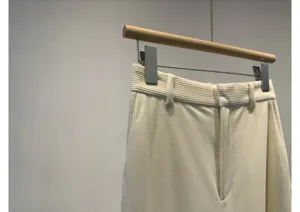 Detailed view of women's soft corduroy trousers waistband and belt loops in cream color.