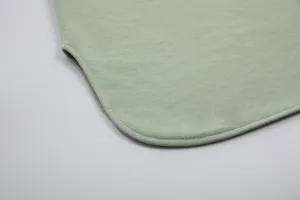 Sage green cotton hoodie sweatshirt curved hem detail, fine stitching, casual apparel close-up.