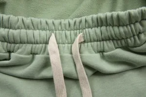 Green cotton casual pants elastic waistband with adjustable drawstring close up detail