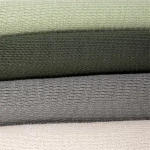 Close-up detail of soft knit fabric in multiple colors showing fine texture and layering.