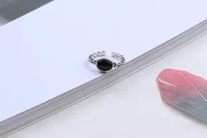 Detailed view of Thai silver open ring featuring a classic black oval stone on white backdrop.