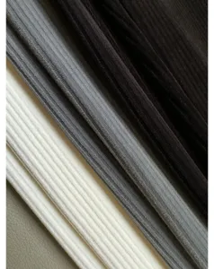 Detailed view of soft stretch corduroy fabric in multiple colors, showing texture and drape.