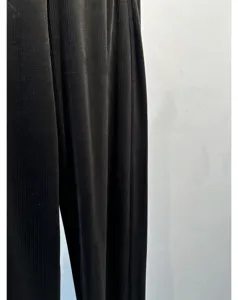 Black corduroy pants fabric texture close-up detail, soft and elegant draped wide leg design.