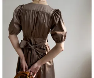 Robe midi marron à manches bouffantes avec joli nœud papillon au dos et en coton doux.