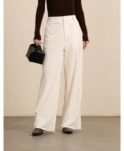 Detail view of women's corduroy wide leg trousers, elegant high waist casual straight pants.
