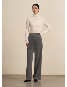 Detailed shot of the stylish grey corduroy wide-leg trousers paired with an elegant turtleneck.