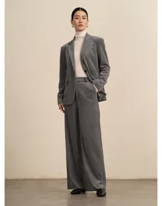 Detailed view of women's grey corduroy wide-leg suit pants and blazer set, elegant look.